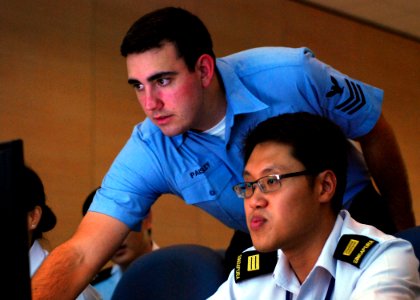 US Navy 090813-N-5207L-087 Information Systems Technician assigned to Command Logistics Group Western Pacific, works with Republic of Singapore Navy Capt