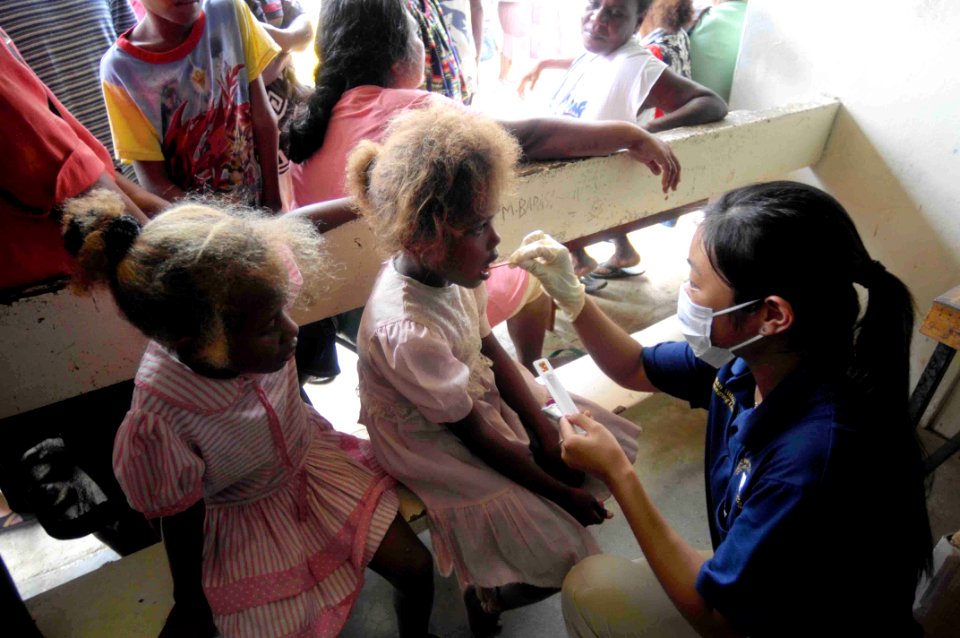 US Navy 090813-N-9689V-003 Mindy Liprovides fluoride treatments to children during a Pacific Partnership 2009 medical civic action project