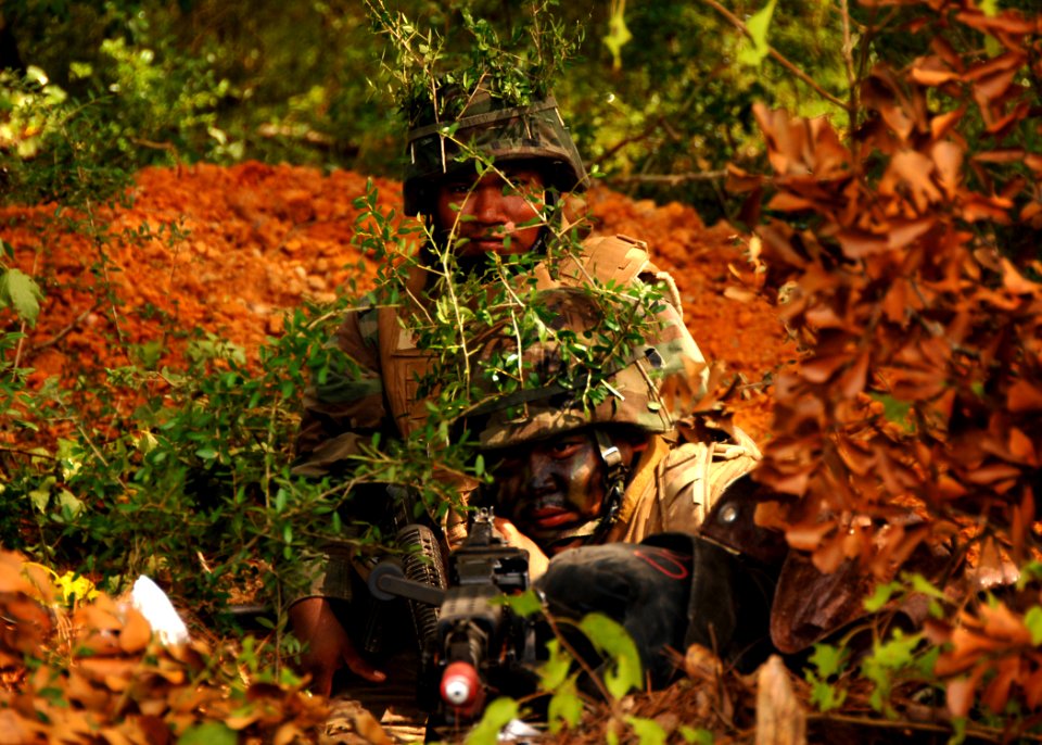 US Navy 090816-N-8816D-156 Seabees assigned to Naval Mobile Construction Battalion (NMCB) 133 scan the area from their fighting position during a field training exercise at Camp Shelby, Miss