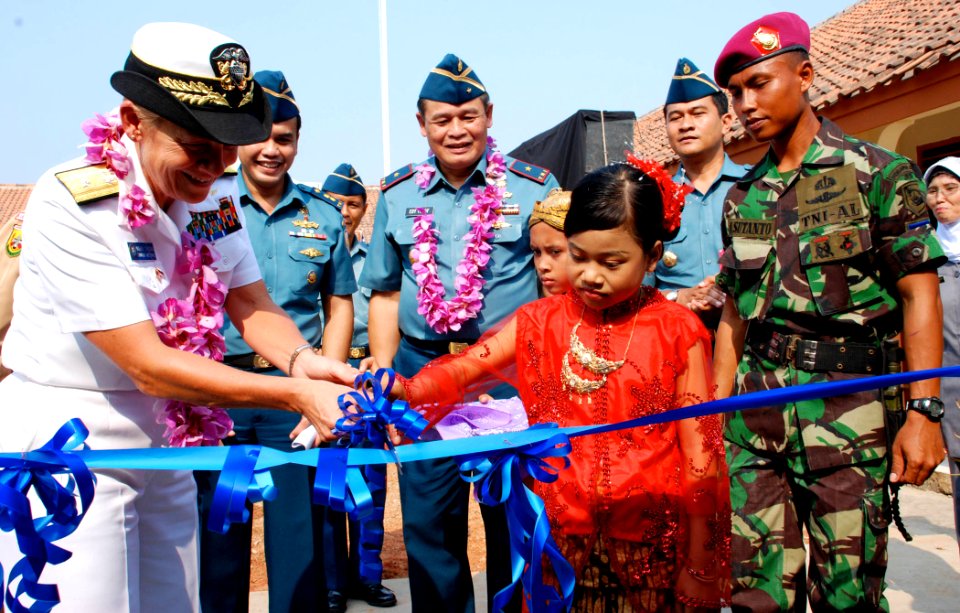 US Navy 090814-N-7095C-173 Rear Adm. Nora Tyson, left, commander of Logistics Group Western Pacific, and a student from Pusaka Rakyat primary school