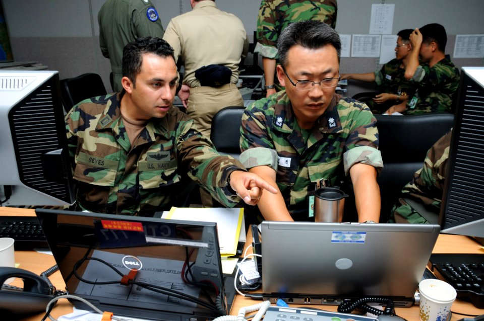 US Navy 090817-N-5086M-009 U.S. Navy Lt. Carlos Reyes, assigned to Naval Mine and Submarine Warfare Command San Diego, and Republic of Korea Navy Lt. Cmdr. Kim Seok-han of the work together as part of the Naval Operations Coord