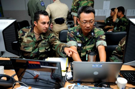 US Navy 090817-N-5086M-009 U.S. Navy Lt. Carlos Reyes, assigned to Naval Mine and Submarine Warfare Command San Diego, and Republic of Korea Navy Lt. Cmdr. Kim Seok-han of the work together as part of the Naval Operations Coord