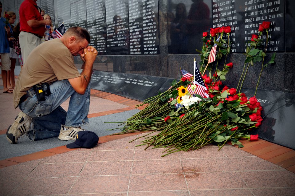 US Navy 090814-N-1522S-008 Mourners place roses and pay their final respects to Captain Michael Scott Speicher at the Jacksonville Veterans Memorial Wall