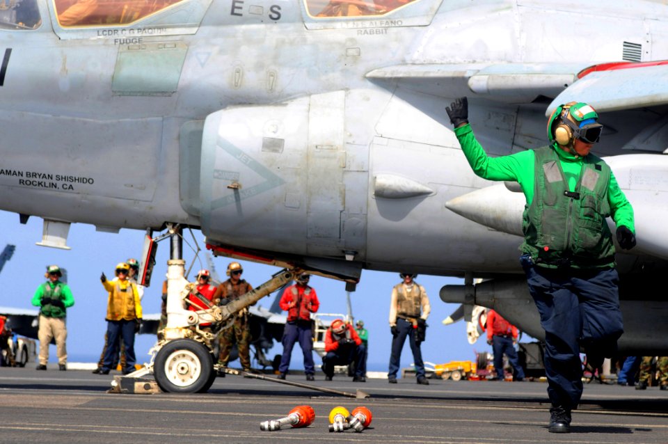 US Navy 090814-N-3610L-198 Aviation Boatswain's Mate (Equipment) 3rd Class Claudia Flores gives a thumbs-up signal to a safety observer as she clears the flight path aboard the aircraft carrier USS Ronald Reagan (CVN 76)