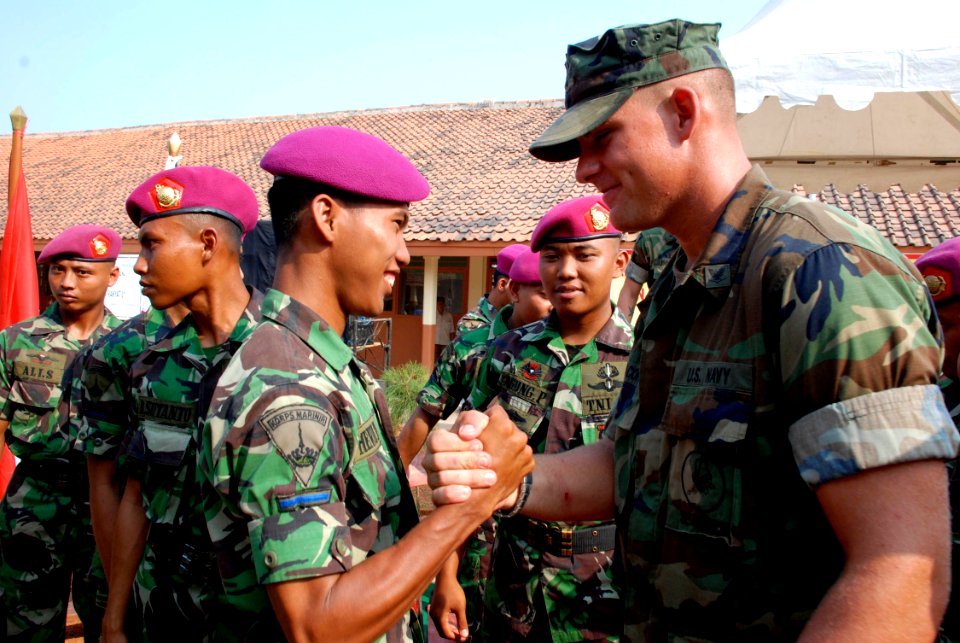 US Navy 090814-N-7095C-227 A U.S. Navy Seabee, assigned to Naval Mobile Construction Battalion (NMCB) 40, says farewell to his counterpart from the Indonesian Marine Corps