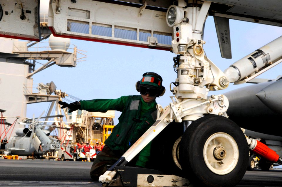 US Navy 090814-N-3610L-280 Aviation Boatswain's Mate (Equipment) 3rd Class Daisy Rivera signals a handler as an aircraft takes tension on a catapult aboard the aircraft carrier USS Ronald Reagan (CVN 76)
