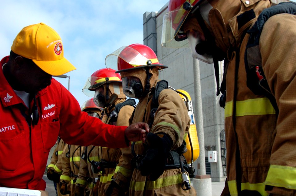 US Navy 090818-N-4047W-085 Damage Controlman 1st Class Robert Battle inspects the damage control Olympics team from Ticonderoga-class guided-missile cruiser USS Mobile Bay (CG 53) for properly donned fire fighting ensembles