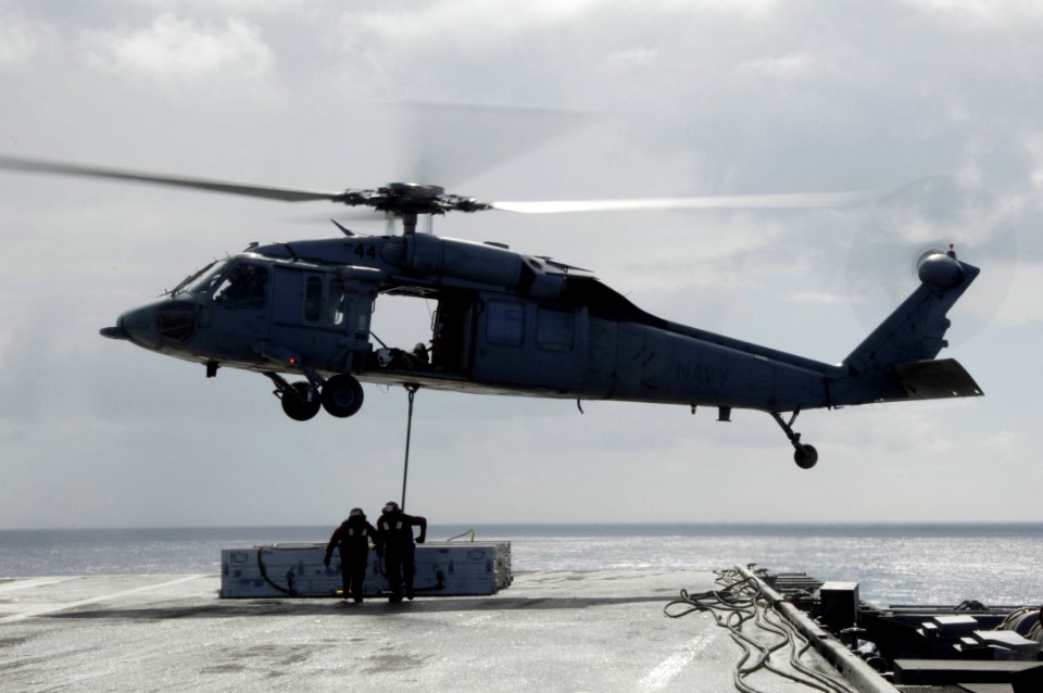 US Navy 090815-N-3038W-189 ailors aboard the aircraft carrier USS Nimitz (CVN 68) attach an ordnance canister to an MH-60S Sea Hawk helicopter assigned to the Wildcards of Helicopter Sea Combat Squadron (HSC 23) during an under