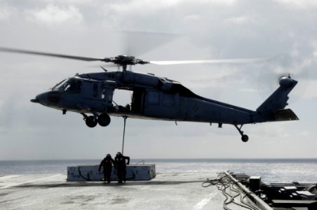 US Navy 090815-N-3038W-189 ailors aboard the aircraft carrier USS Nimitz (CVN 68) attach an ordnance canister to an MH-60S Sea Hawk helicopter assigned to the Wildcards of Helicopter Sea Combat Squadron (HSC 23) during an under