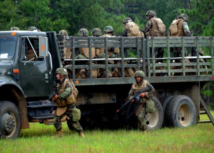 US Navy 090819-N-1120L-024 Seabees assigned to Naval Mobile Construction Battalion (NMCB) 22 respond to an attack from aggressors from NMCB-7 during a site sweep field training exercise