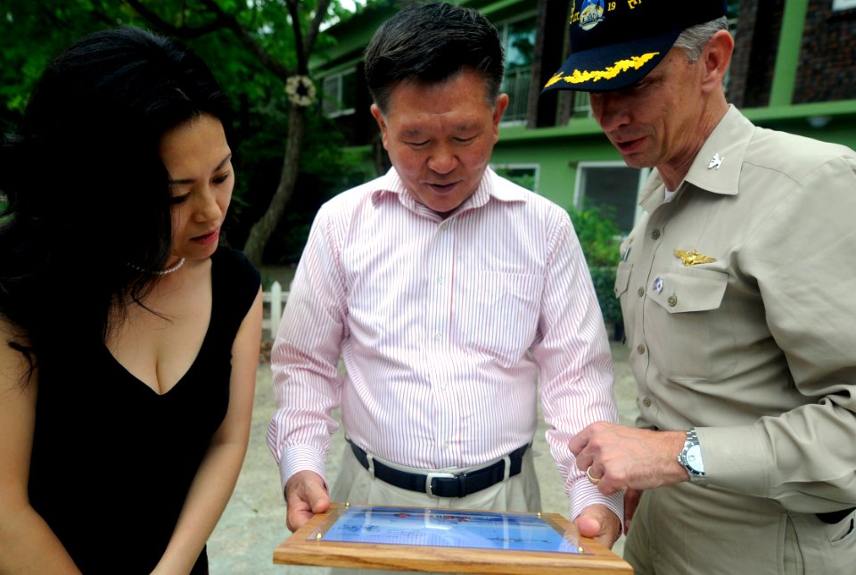 US Navy 090817-N-7280V-457 So Ang Park, deputy director of the Hee-Rak-Won Children's Welfare Facility and the facility director, Hyo Il, look at a plaque presented by Capt. Thom W. Burke, commanding officer of the amphibious c