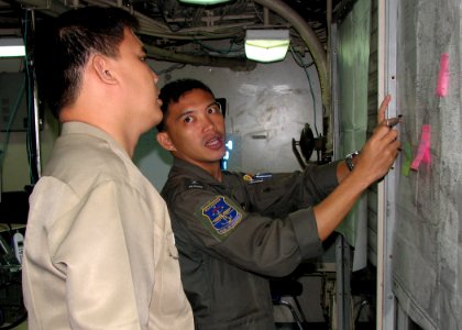 US Navy 090818-N-7058E-038 Republic of the Philippines Navy Lt. Mickey Simeon shows Lt. Mark Christopher the course of a vessel participating in a field training exercise during Southeast Asia Cooperation Against Terrorism