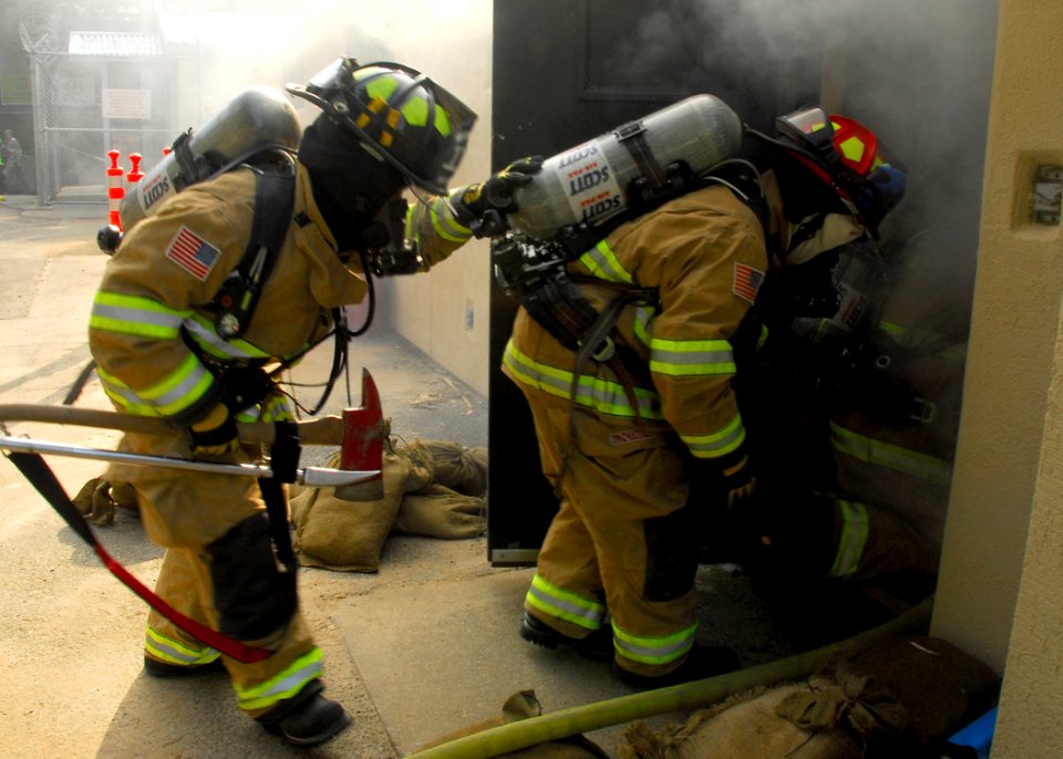 US Navy 090819-N-9573A-007 Firefighters enter a smoke-filled space during a fire saboteur drill