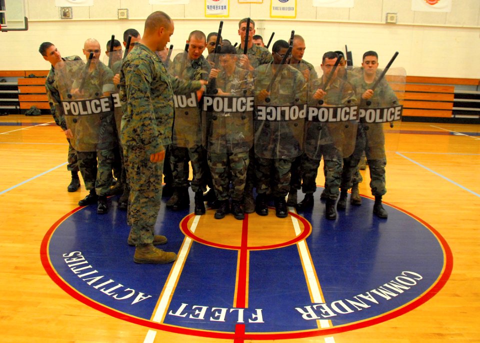 US Navy 090817-N-9573A-010 Capt. Brian Marthiljohni, from Celina, Texas a platoon commander from Fleet Anti-terrorism Security Team, Company Pacific (FASTPAC), instructs Sailors during riot training