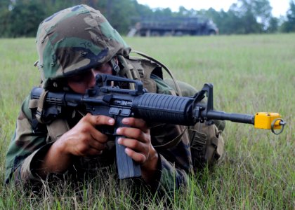 US Navy 090819-N-1120L-036 A Seabee assigned to Naval Mobile Construction Battalion (NMCB) 22 conducts an immediate action drill during a field training exercise photo