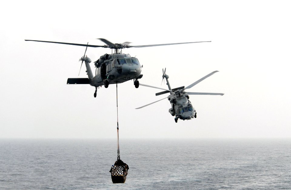 US Navy 090820-N-5586R-023 HH-60H Sea Hawk helicopters assigned to the Black Knights of Helicopter Anti-Submarine Squadron (HS) 4 maneuver around each other to transfer cargo