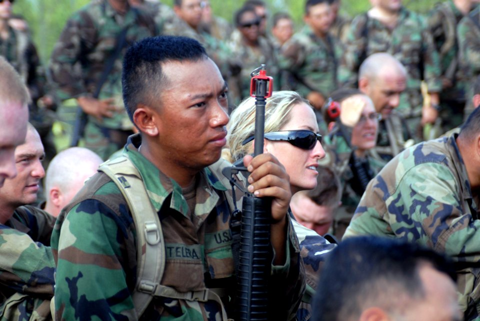 US Navy 090819-N-1580K-123 Construction Mechanic Constructionman Apprentice Frank Fontelera, left, and Equipment Operator 2nd Class Cathryn Brannan listen to an exercise brief from Cmdr. Ernst K. Walge
