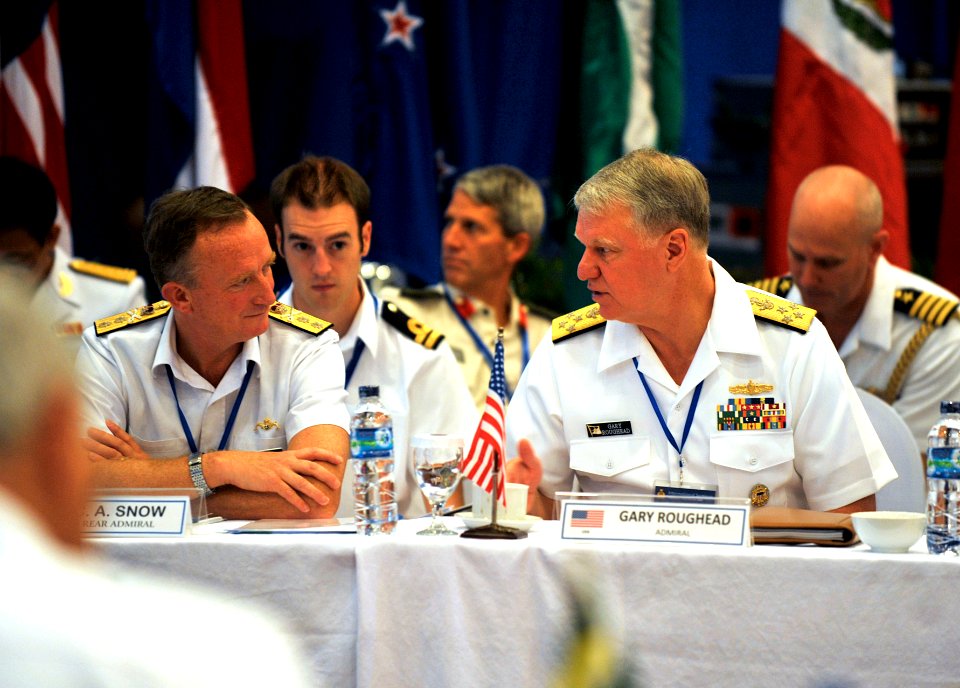 US Navy 090818-N-8273J-062 Chief of Naval Operations (CNO) Adm. Gary Roughead, right, speaks with Rear Adm. C.A Snow, representative for the Royal Navy Chief of Naval Staff, during the International Maritime Seminar in Manado,