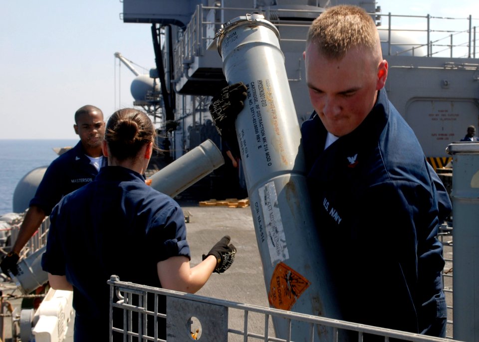 US Navy 090817-N-5215E-025 Fire Controlman 2nd Class Stephen Woodall packs rounds for the Mark 36 super rapid blooming off-board chaff for offload from the amphibious assault ship USS Essex (LHD 2)