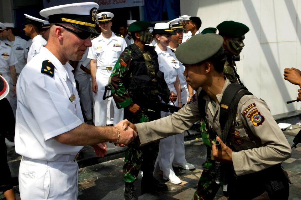 US Navy 090818-N-9123L-054 Chief Warrant Officer Terry Boone, from Houston, Texas greets an Indonesian police officer
