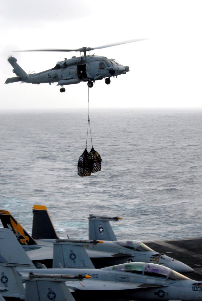 US Navy 090820-N-5586R-085 An HH-60H Sea Hawk helicopter assigned to the Black Knights of Helicopter Anti-Submarine Squadron (HS) 4 prepares to deliver cargo transferred from the Military Sealift Command fast-combat support shi