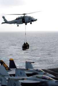 US Navy 090820-N-5586R-085 An HH-60H Sea Hawk helicopter assigned to the Black Knights of Helicopter Anti-Submarine Squadron (HS) 4 prepares to deliver cargo transferred from the Military Sealift Command fast-combat support shi