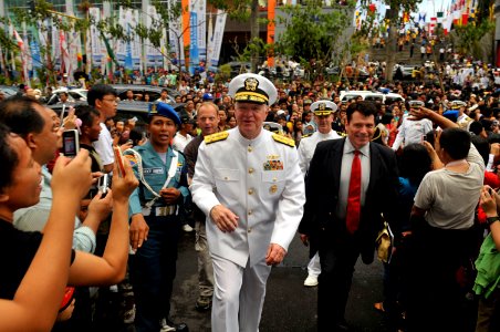 US Navy 090819-N-8273J-649 Chief of Naval Operations (CNO) Adm. Gary Roughead and U.S. Ambassador to Indonesia, the Honorable Cameron Hume, walk through the crowded streets of Manado