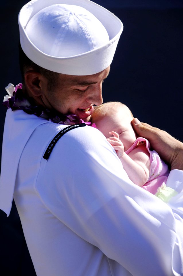 US Navy 090821-N-7498L-097 Gas Turbine System Technician (Electrical) 3rd Class Brent Palmer sees his daughter for the first time as the guided-missile destroyer USS Paul Hamilton (DDG 60) returns to homeport at Naval Station P