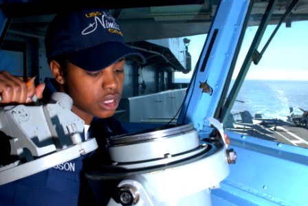 US Navy 090819-N-2600H-002 Quartermaster 3rd Class Kabresha Richardson checks navigational equipment on the bridge of the aircraft carrier USS Nimitz (CVN 68)
