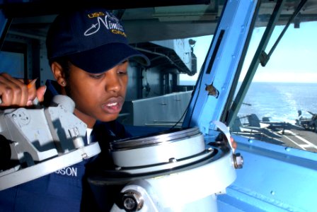 US Navy 090819-N-2600H-002 Quartermaster 3rd Class Kabresha Richardson checks navigational equipment on the bridge of the aircraft carrier USS Nimitz (CVN 68) photo