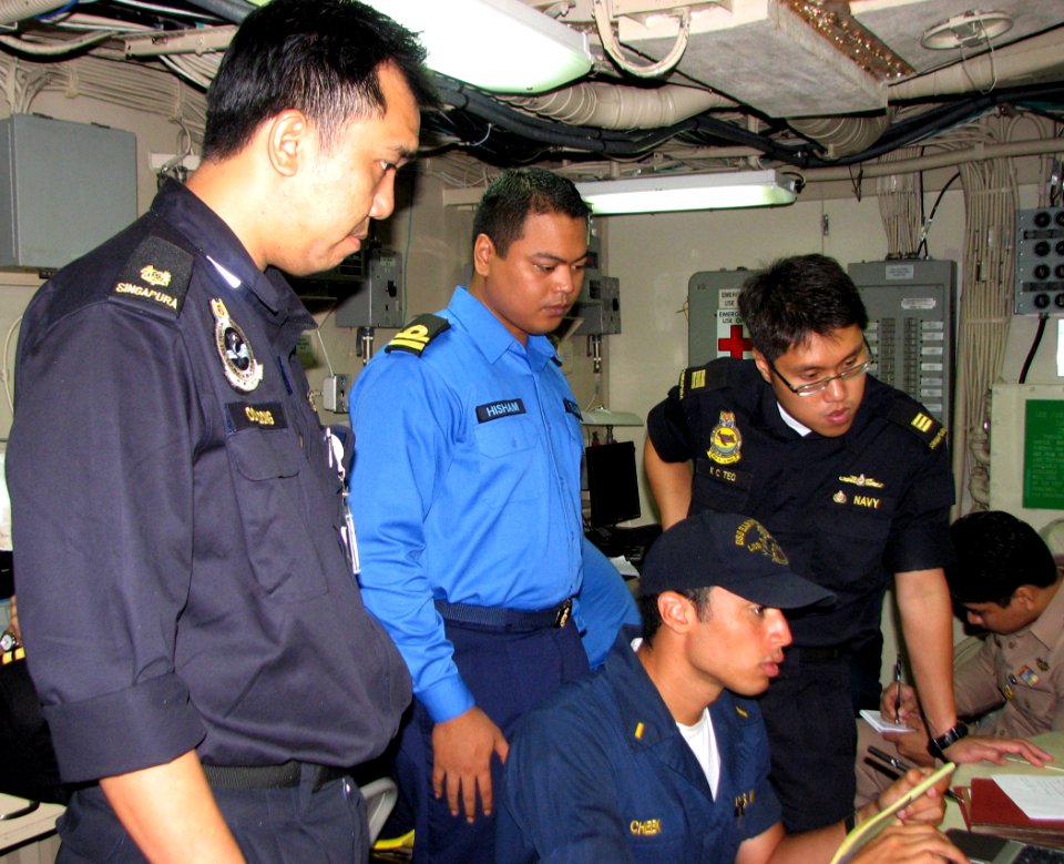 US Navy 090818-N-7058E-047 Republic of Singapore Navy Maj. Ooi Loong, Royal Malaysian Navy Lt. Hisham and Republic of Singapore Navy Capt. K.C. Teo observe U.S. Navy Ensign Duran Cheek