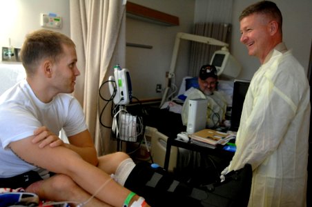 US Navy 090819-N-9818V-063 Master Chief Petty Officer of the Navy (MCPON) Rick West talks with U.S. Marine Corps Cpl. Charles Leak and his father, Richard from Buford, Ga. at National Naval Medical Center