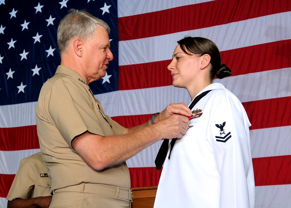 US Navy 090819-N-6233H-144 Chief of Naval Operations (CNO) Adm. Gary Roughead presents Damage Controlman 2nd Class Stephanie Jeffcoat with the Navy and Marine Corps medal during a visit aboard the aircraft carrier USS George Wa