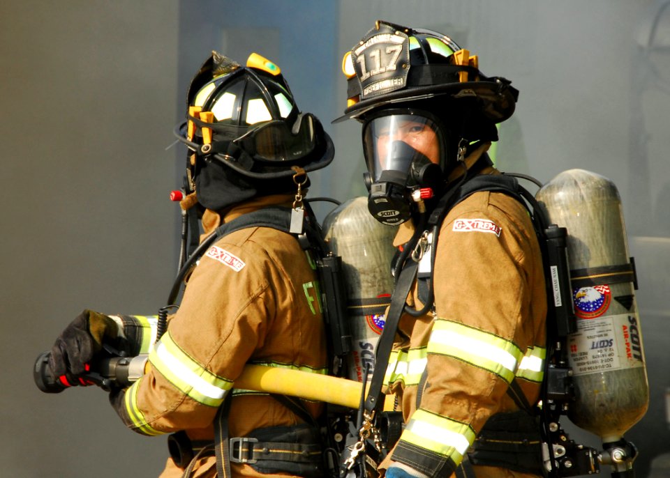 US Navy 090819-N-9573A-014 Fire fighters Min Hwan Pak (right), looks back as Sang Chun An (left), both Chinhae residents, prepare to enter a smoke-filled space during a fire saboteur drill