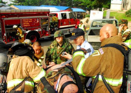 US Navy 090819-N-9573A-018 Firefighters and medical personnel prepare a training dummy for transport to a medical facility during a fire saboteur drill