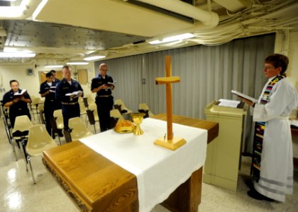 US Navy 090823-N-2147L-001 Lt. Cmdr. Laura Bender, command chaplain aboard the amphibious transport dock ship Pre-Commisioning Unit (PCU) New York (LPD 21), delivers the first religious ceremony in the chapel photo