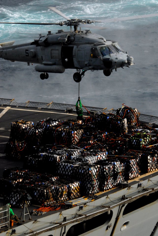 US Navy 090820-N-5586R-046 An MH-60S Sea Hawk helicopter assigned to the Blackjacks of Helicopter Sea Combat Squadron (HSC) 21 is loaded with cargo from the Military Sealift Command fast-combat support ship USNS Rainier (T-AOE