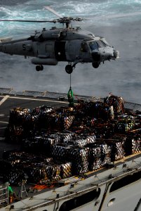 US Navy 090820-N-5586R-046 An MH-60S Sea Hawk helicopter assigned to the Blackjacks of Helicopter Sea Combat Squadron (HSC) 21 is loaded with cargo from the Military Sealift Command fast-combat support ship USNS Rainier (T-AOE