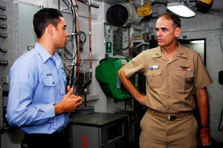 US Navy 090820-N-6538W-139 Vice Adm. Thomas Kilcline, Commander, Naval Air Forces, Speaks with Aviation Boatswain's Mate (Equipment) 2nd Class Dennis Archer, from Miami, about the arresting gear engines aboard the aircraft carr