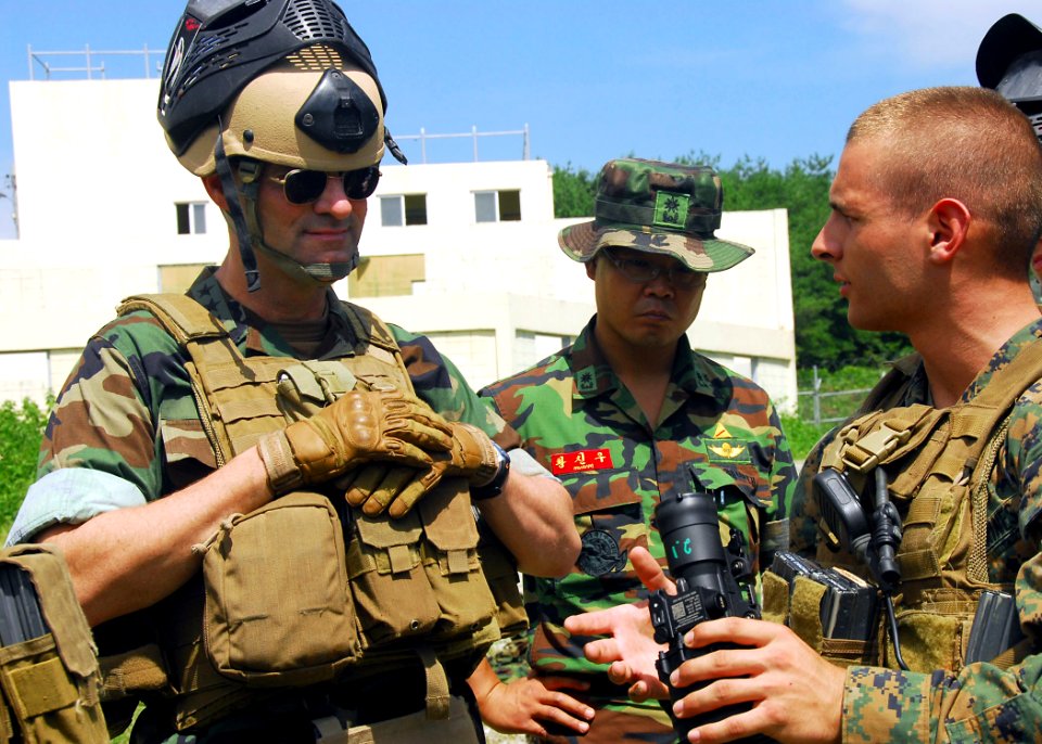 US Navy 090823-N-9573A-028 Lance Cpl. Tom Canzano, right, of Farmington, N.Y., assigned to Fleet Anti-terrorism Security Team Pacific (FAST PAC), explains to Vice Adm. John M. Bird, left, commander, U.S. 7th Fleet