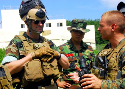 US Navy 090823-N-9573A-028 Lance Cpl. Tom Canzano, right, of Farmington, N.Y., assigned to Fleet Anti-terrorism Security Team Pacific (FAST PAC), explains to Vice Adm. John M. Bird, left, commander, U.S. 7th Fleet