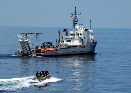 US Navy 090824-N-1522S-005 A visit, board, search, and seizure team from the guided-missile destroyer USS Farragut (DDG 99) approaches the Navy training boat USNS Hunter (8202) during a visit, board, search, and seizure trainin photo