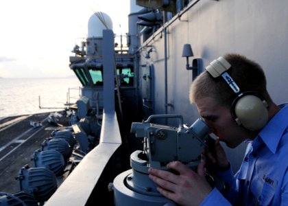 US Navy 090822-N-1644H-071 Quartermaster 3rd Class William Stephens, assigned to the navigation department of the aircraft carrier USS George Washington (CVN 73), takes a navigational reading with a sexton