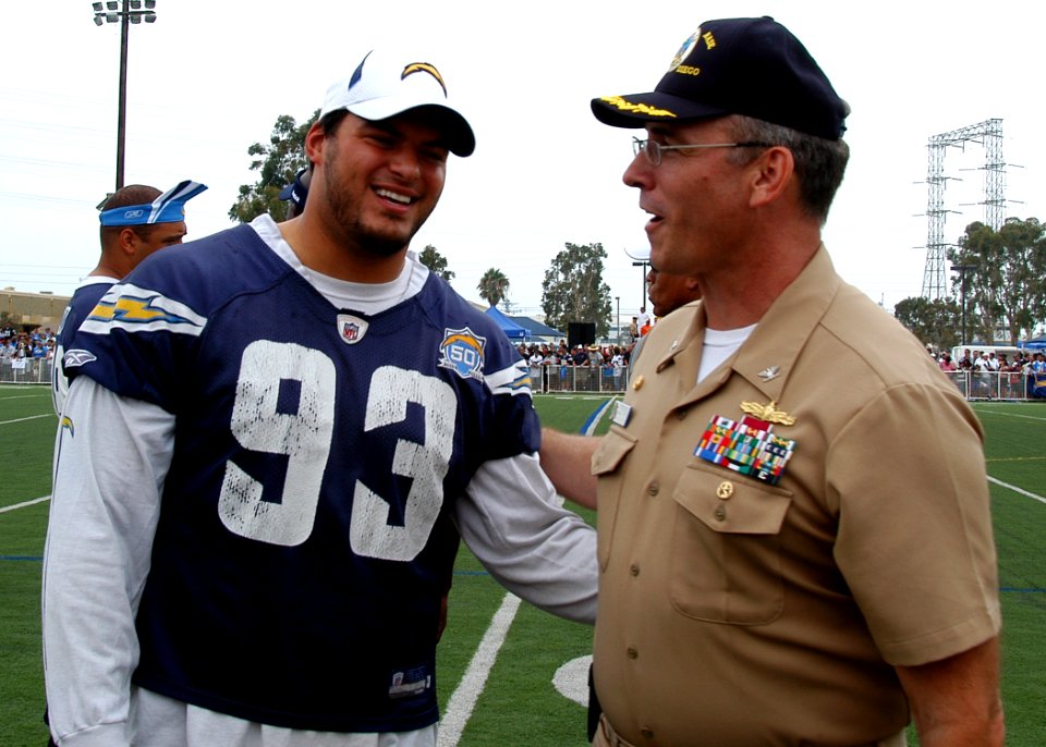 US Navy 090821-N-0483R-040 Capt. Ricky L. Williamson, commanding officer of Naval Base San Diego, speaks with San Diego Chargers defensive end Luis Castillo during a 45-minute, no-pads practice at Naval Base San Diego