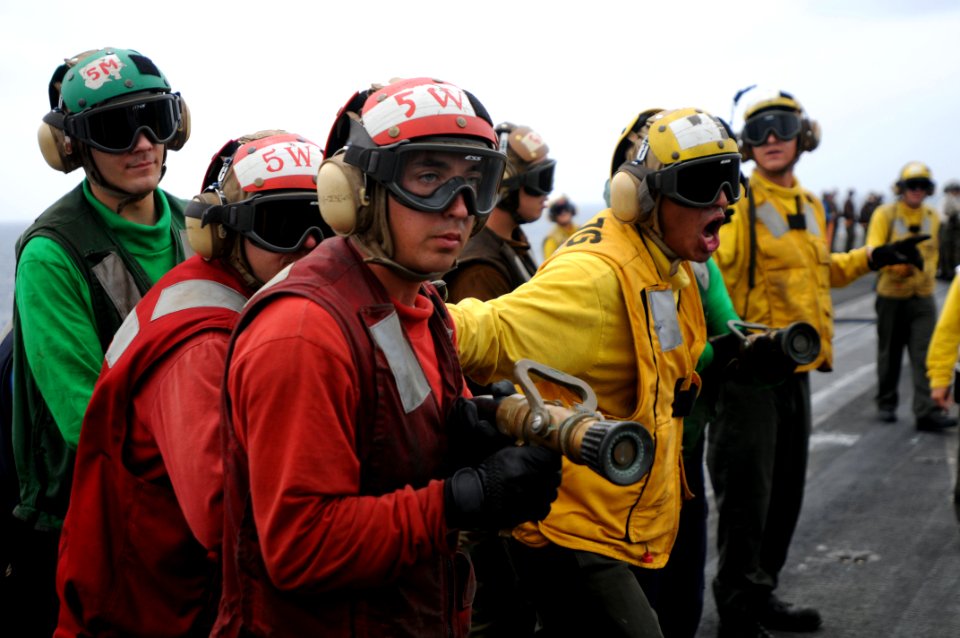 US Navy 090821-N-9132C-162 Members of the flight deck crew of the aircraft carrier USS Ronald Reagan (CVN 76) man fire hoses during a flight deck drill