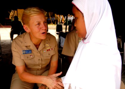 US Navy 090825-N-8539M-109 Rear Adm. Nora Tyson, commander, Logistics Group Western Pacific, meets a young student at Nural Falah Elemetary School