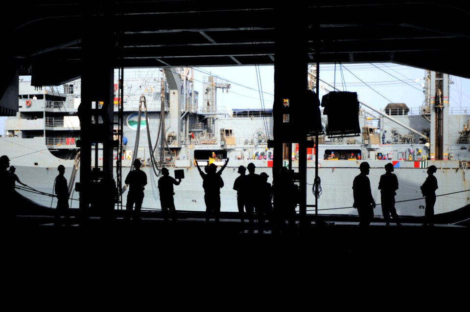 US Navy 090820-N-9132C-065 Sailors aboard the aircraft carrier USS Ronald Reagan (CVN 76) receive cargo from the Military Sealift Command fast combat-support ship USNS Rainier (T-AOE 7) during a replenishment at sea