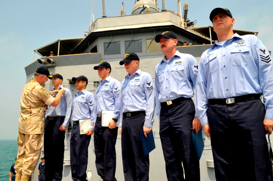 US Navy 090822-N-8273J-050 Chief of Naval Operations (CNO) Adm. Gary Roughead awards Enlisted Surface Warfare pins to six Sailors while aboard the guided-missile frigate USS Thatch (FFG 43)