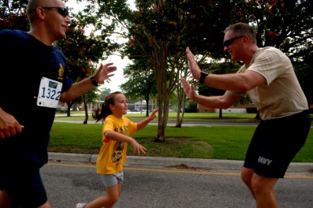 US Navy 090822-N-9818V-293 U.S. Fleet Forces Command Fleet Master Chief Tom Howard cheers on racers participating in the fifth annual Run with the Chiefs 5 kilometer run at Naval Station Norfolk