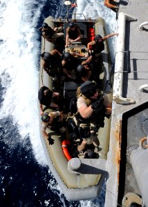 US Navy 090826-N-6814F-152 U.S. Coast Guard Machinery Technician 1st Class William Porter, assigned to maritime safety and security team 91104, climbs a caving ladder during visit, board, search, and seizure training exercise a